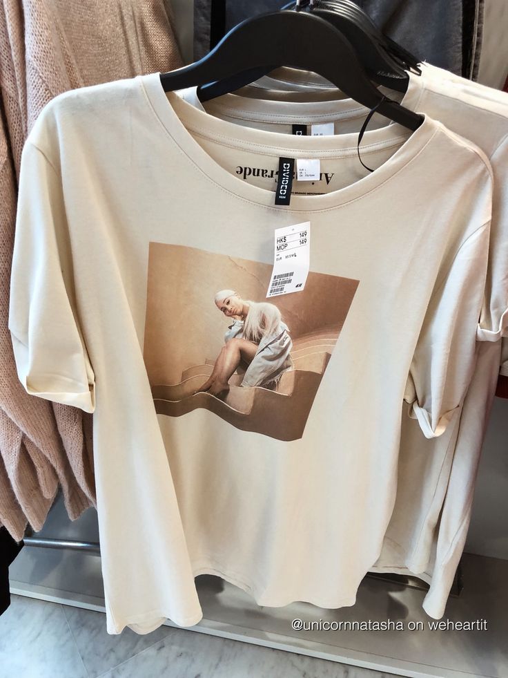 a white t - shirt with an image of a woman on it