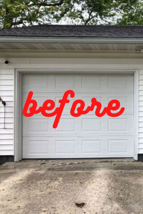 a garage door with the words before painted on it in front of a white house