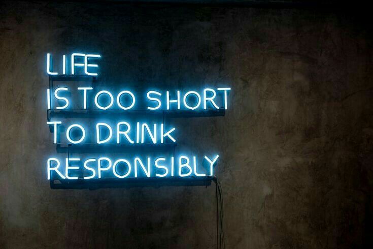 a neon sign that says life is too short to drink responsiblely on the wall