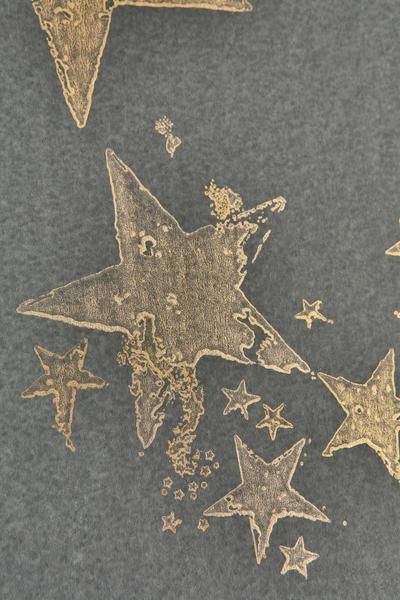 some gold stars on a black surface