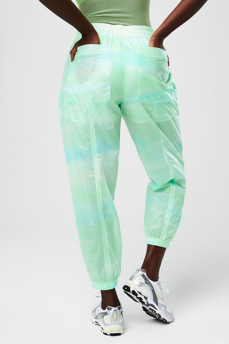 Sheer Ripstop Parachute Pant Fabletics green female Activewear >> Womens >> Bottoms >> Pants & Joggers >> Lounge Pants plus Everyday External Pockets Green Nylon Sports Pants, Green Nylon Sport Pants, Green Athleisure Bottoms For Loungewear, Athleisure Green Bottoms For Loungewear, Green Tapered Leg Sweatpants With Elastic Waistband, Sporty Green Yoga Bottoms, Green Stretch Athleisure Pants, Spring Athleisure Cargo Pants With Tapered Leg, Green Athleisure Cargo Pants For Sports