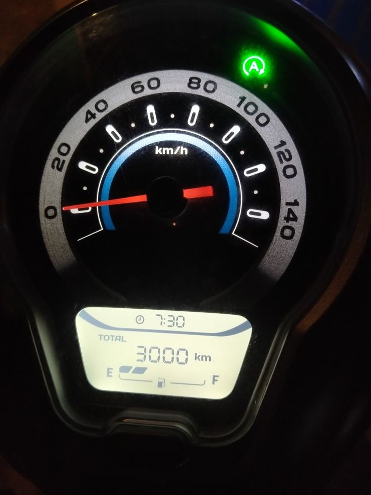 the speedometer on a motorcycle is lit up with green and red lights