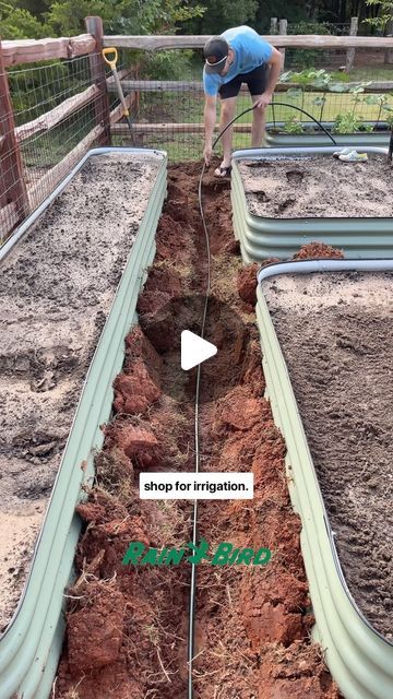 a man is digging in the ground with a garden hose