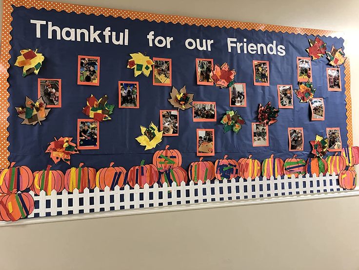 a bulletin board is decorated with pumpkins and leaves for the school's thanksgiving decorations