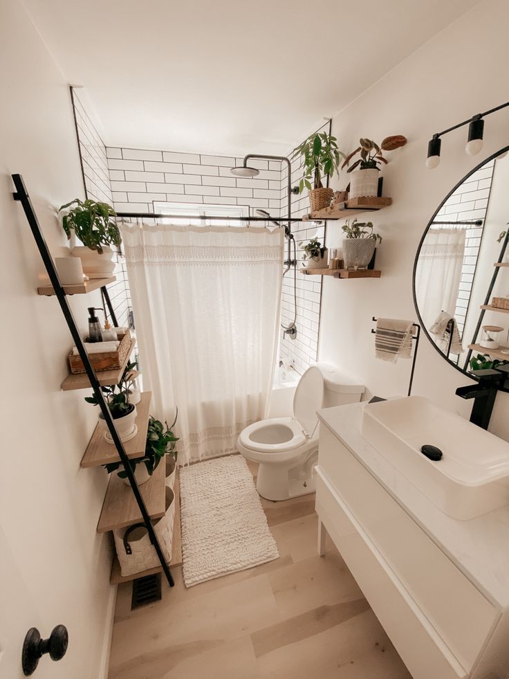 a bathroom with a toilet, sink and mirror