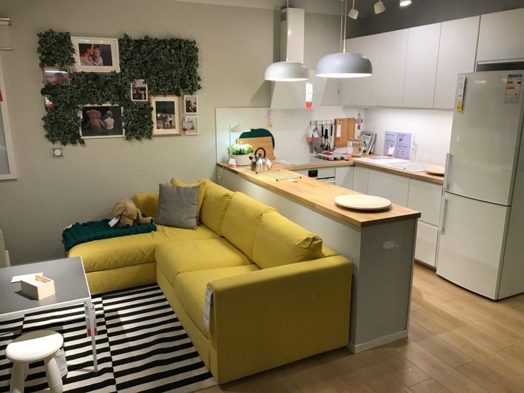 a yellow couch sitting in the middle of a kitchen