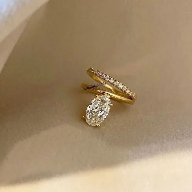 two diamond rings sitting on top of each other