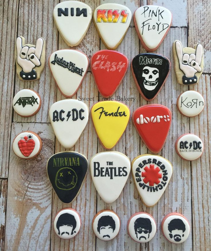 the beatles cookies are arranged on top of each other in different shapes and sizes, all decorated to look like guitar picks