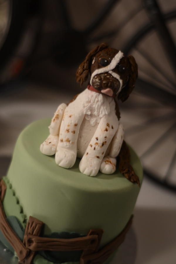 a cake decorated with a dog sitting on top of it