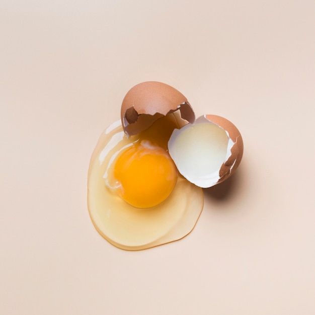 an egg is broken in half on a white surface