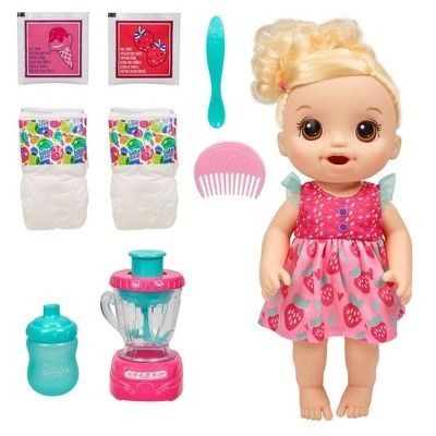 a baby doll with accessories including a blender, bottle and comb