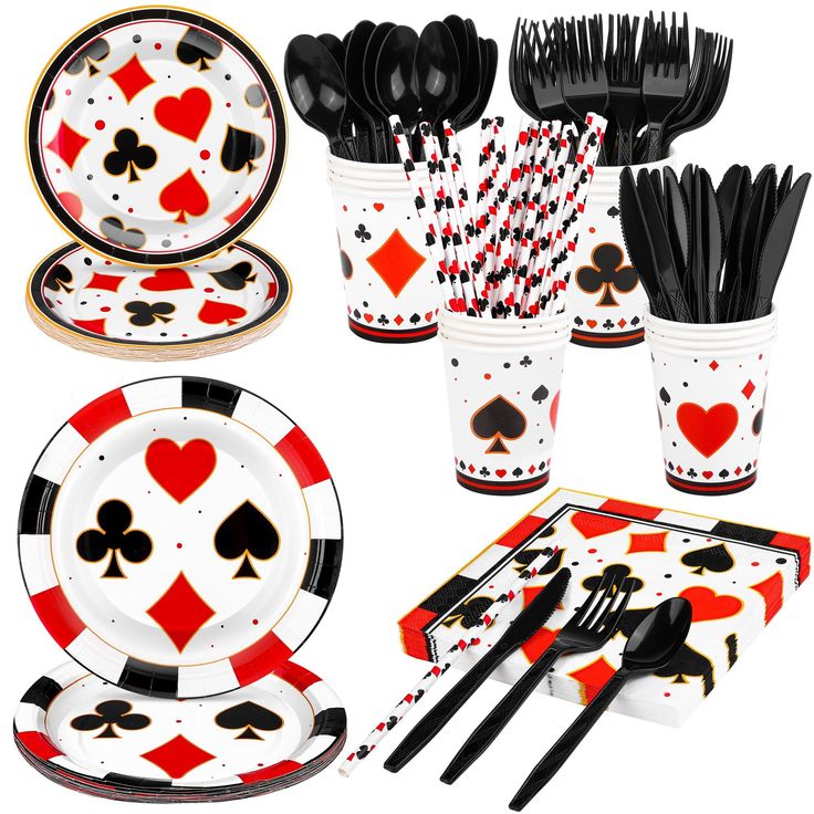 a table set with black and red playing cards on the plates, cups, forks, spoons and utensils