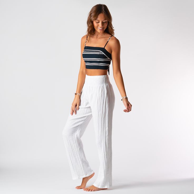 Getting dressed just got easier. Trendy yet timeless, these cotton wide leg pants feature a smocked high waistband and flowy fit from the knee down. Handcrafted with 100% cotton and designed for comfort, these loose, lightweight pants are perfect for lounging on the beach, a morning coffee run, or happy hour with the gals! Shop All Wide Leg Pants Wide Leg Cotton Pants, Cotton Gauze Pants, Harlem Pants, Cotton Wide Leg Pants, Gauze Pants, White Wide Leg Pants, Cotton Gauze Fabric, Lightweight Pants, Gauze Fabric