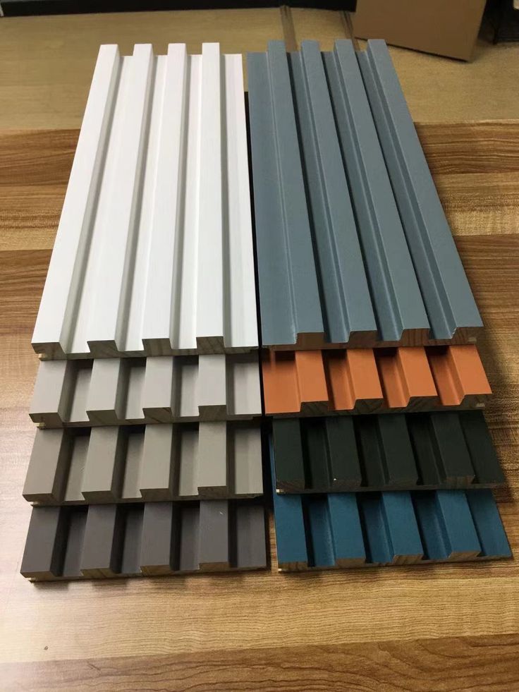 several different colors of aluminum profiles on a wooden floor