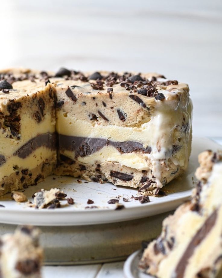 a cake with chocolate and white frosting on it sitting on a plate next to another piece of cake