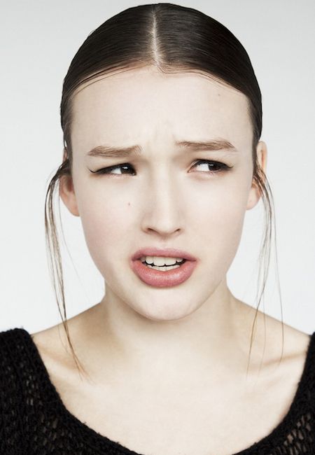 a young woman with her mouth open and an angry look on her face