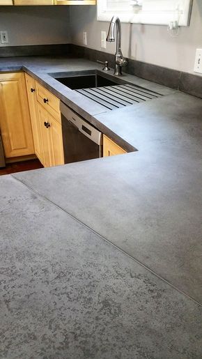 a kitchen counter with a sink and dishwasher