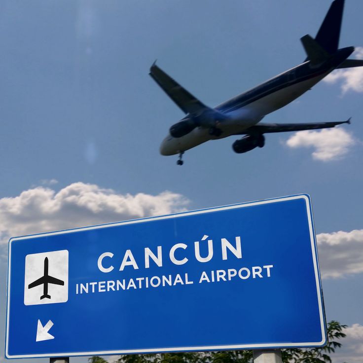 an airplane flying in the sky above a sign