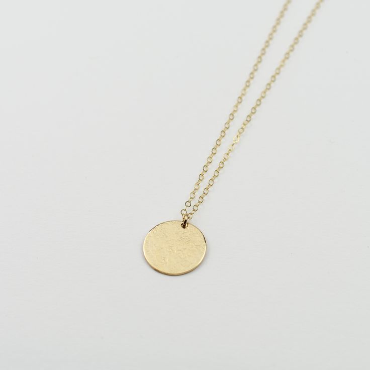 "14K solid gold coin necklace - Hammered disc necklace The perfect everyday, every occasion necklace. This necklace will dress up a casual blouse or look stunning with an evening dress. If you only had one necklace, this is the necklace you want. The necklace will arrive in a nice gift box, ready for delivery. 14K solid gold disc, it is 22 gauge (Please select the size of the disc, the model wears a 5/8\" disc necklace) 14K gold 1.5mm chain All components are 14k gold Please read our policies be Elegant 14k Gold-filled Coin Necklace, 14k Yellow Gold Circle Necklace, Everyday Round Disc Coin Pendant Jewelry, Everyday Jewelry With Coin Pendant, Elegant Everyday Charm Necklace With Coin Pendant, 14k Gold Medallion Necklace With Round Pendant, Elegant Everyday Coin Pendant Charm Necklace, 14k Gold Circular Coin Pendant Necklace, 14k Gold Circle Necklace With Coin Pendant