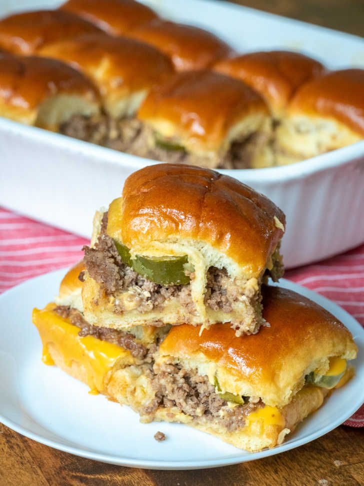 two sandwiches stacked on top of each other in front of a casserole dish