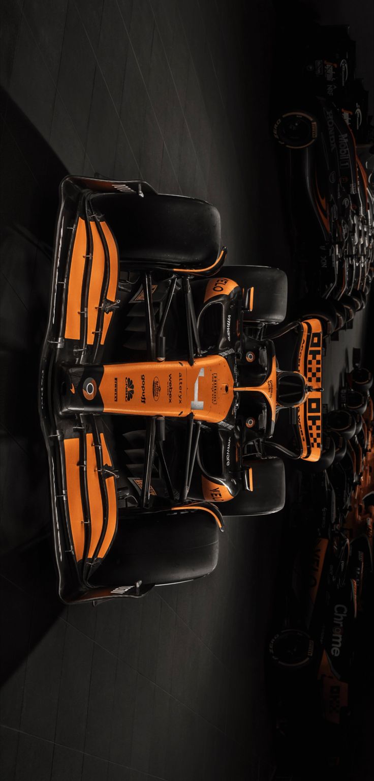 an orange and black race car is shown from above