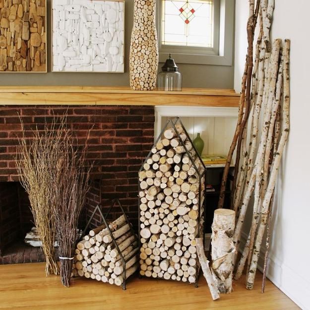 there are many logs stacked next to each other in front of a fireplace mantel