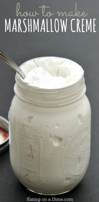 a jar filled with marshmallow creme next to a spoon on a table