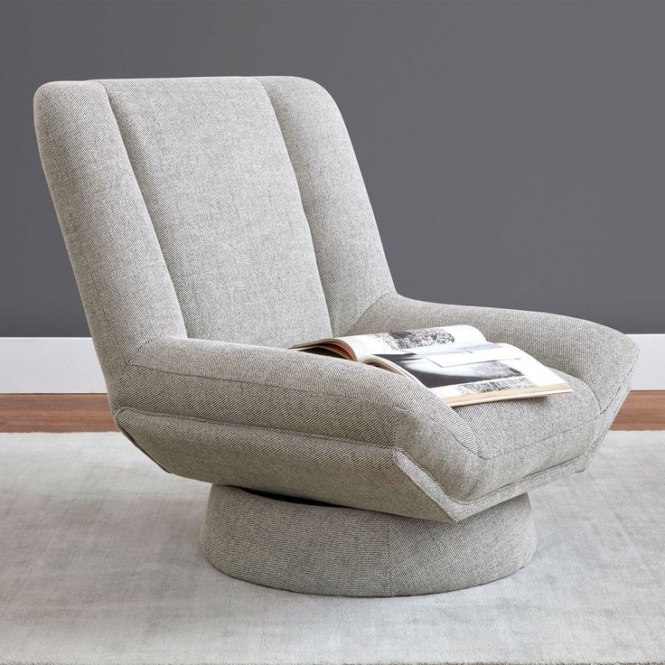 a gray chair with a magazine on it