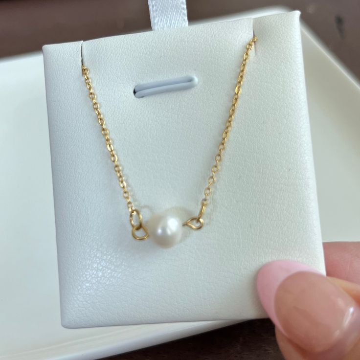 Enhance your feminine grace with our Single Pearl Necklace. Made with a dainty, cute design, this necklace will add a touch of girly elegance to any outfit. Stand out and make a statement with this unique and sophisticated accessory. 15 inches long + 2 inches ext 18K PVD gold plated stainless steel Fresh Water Pearl Pendant Non Tarnish And Water Resistant Dainty Gold-plated Charm Necklace With Pearl Pendant, Hypoallergenic 14k Gold Necklace, Simple Pearl Necklace As Gift, Minimalist Gold Plated Pearl Necklace With Adjustable Chain, Dainty Gold-plated Necklace With Pearl Pendant, Dainty Gold Plated Necklace With Pearl Pendant, Minimalist Gold-plated Pearl Necklace With Adjustable Chain, Elegant Adjustable Necklace As Gift For Her, Dainty Adjustable Pearl Necklace For Gift