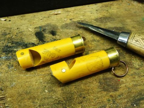 two yellow pencils sitting on top of a table next to a pair of scissors