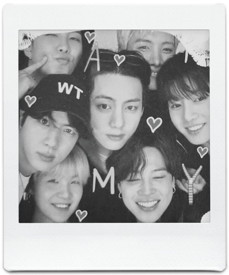 a group of people that are posing for a picture with hearts on their hats and letters