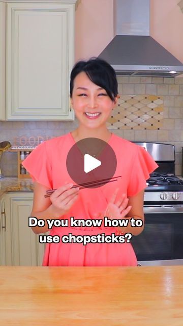 a woman standing in front of a kitchen counter with the words do you know how to use chopsticks?