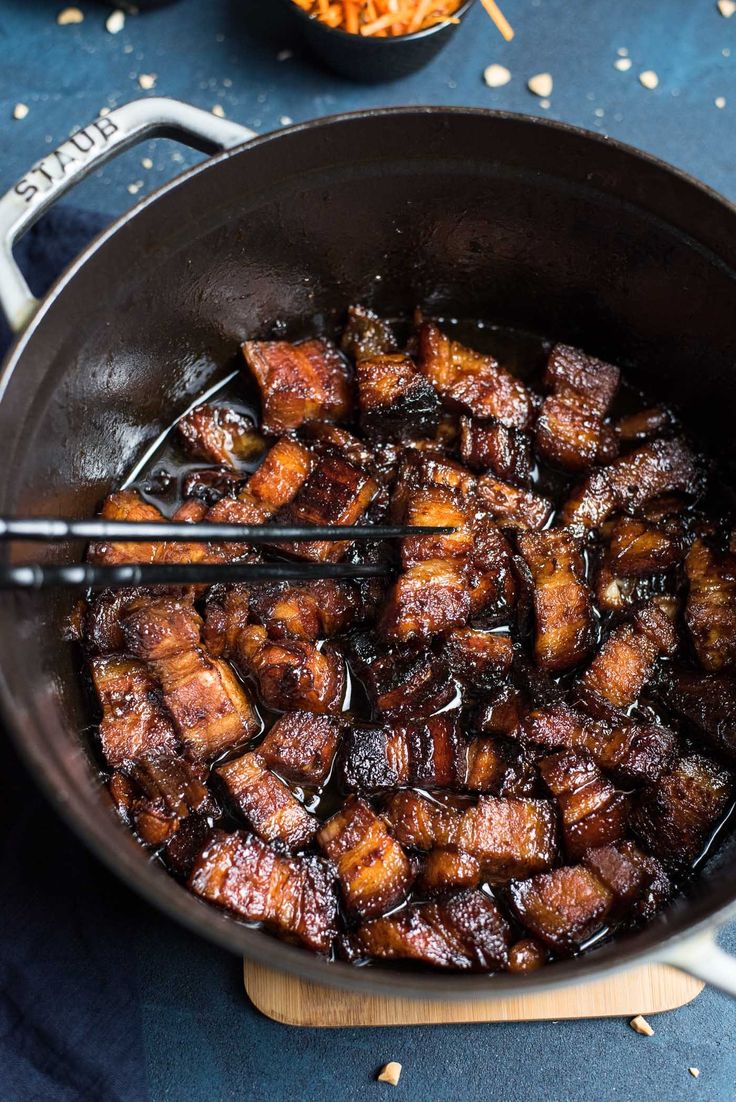 food being cooked in a pan with chopsticks