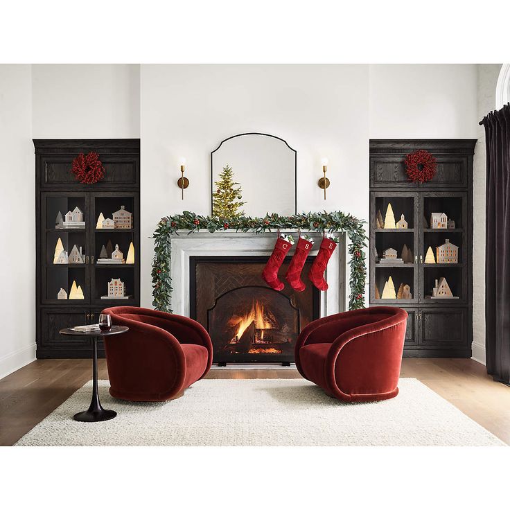 a living room decorated for christmas with stockings on the fireplace and stockings hanging from the mantle