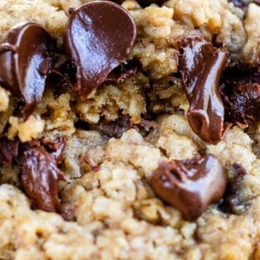 chocolate chips and oatmeal cookies are piled on top of each other