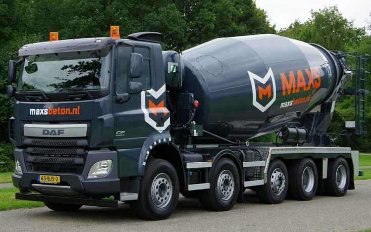 a large cement truck parked on the side of a road