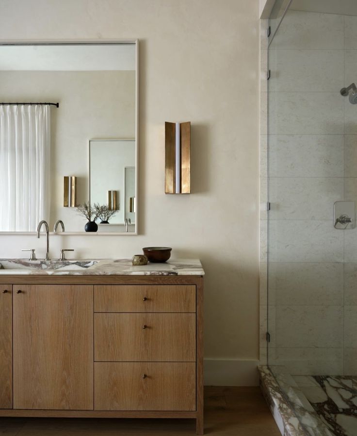 a bathroom with two sinks and a large mirror