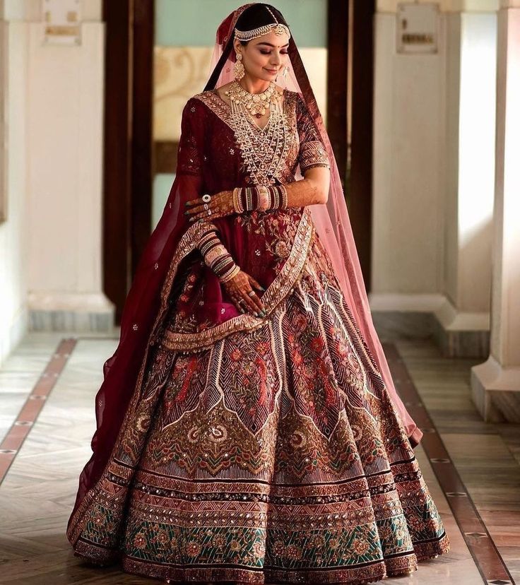 a woman in a red and gold bridal gown