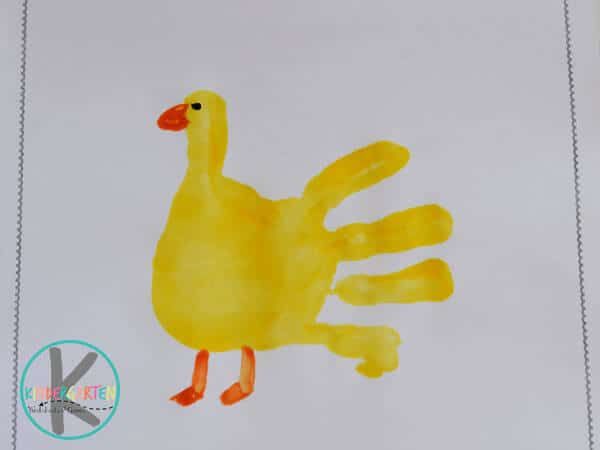 a child's handprint with a yellow duck on it