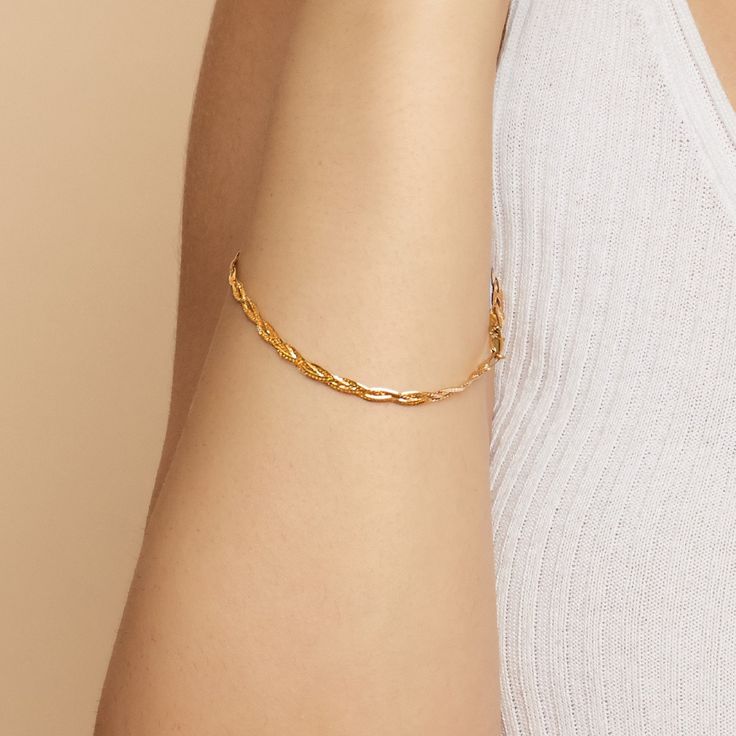 #All Full of vintage allure, our Now & Forever Herringbone Bracelet is a modern take on a true classic. Three petite herringbone chains weave together to form a chic braid of solid gold. The Finer Points: #YellowGold-10kSolidGold-75 Metal: 10k Solid Yellow Gold Dimensions: 3.4mm Wide, 7.5-Inches Long Weight: 2.7 Grams Solid Gold Origin: Crafted in Istanbul, Turkey #TricolorGold-10kSolidGold-75 Metal: 10k Solid Tricolor Gold Dimensions: 3.4mm Wide, 7.5-Inches Long Weight: 2.7 Grams Solid Gold Ori Elegant Adjustable Gold Bracelet With Curb Chain, Gold Plated Curb Chain Bracelets, Elegant Curb Chain Bangle, Dainty Jewelry With Curb Chain, Modern Twist Everyday Bracelet Jewelry, Adjustable Curb Chain Bracelets, Modern Twist Everyday Bracelet, Elegant Gold Curb Chain Bangle Bracelet, Elegant Gold-plated Curb Chain Bracelet