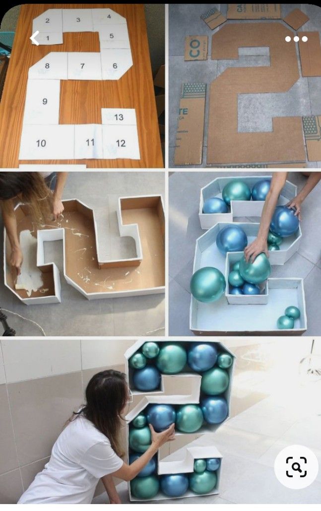 several different pictures of letters made out of cardboard and some blue balls on the floor