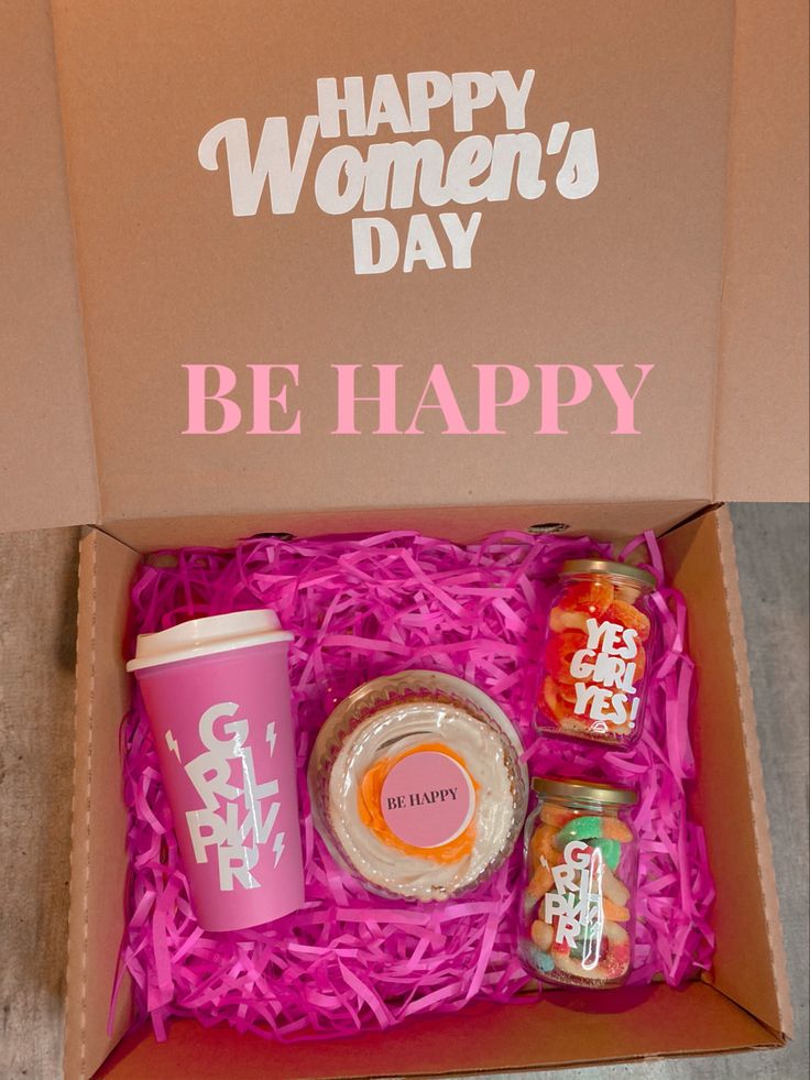 an open box with food and drink on the inside that says happy women's day