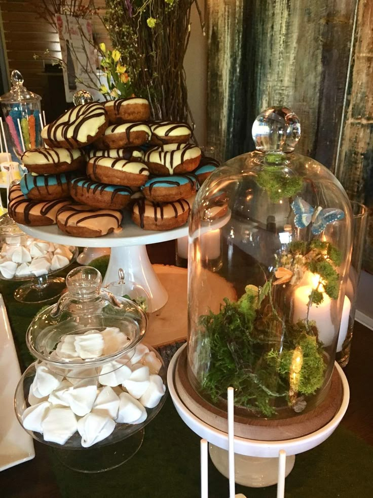 an assortment of desserts under a glass dome