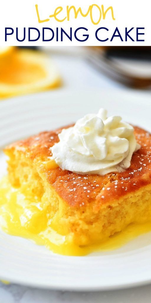 lemon pudding cake on a white plate with whipped cream