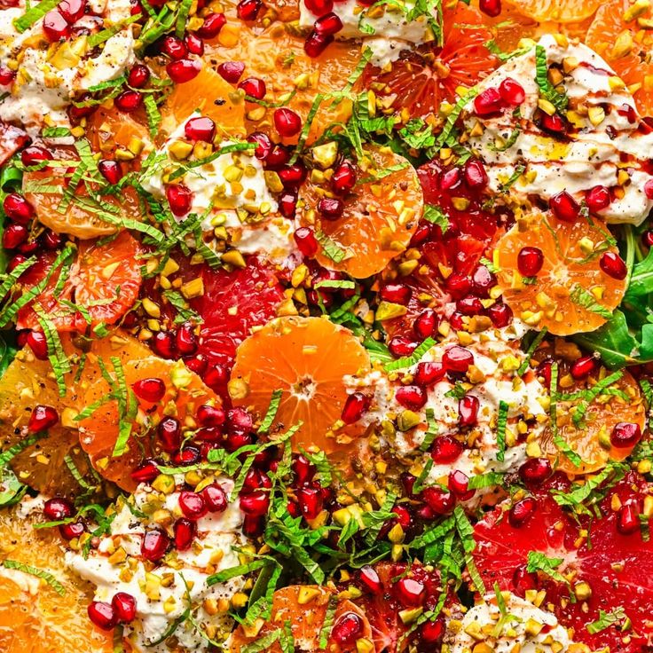 an orange salad with cranberries and other toppings on the top is ready to be eaten