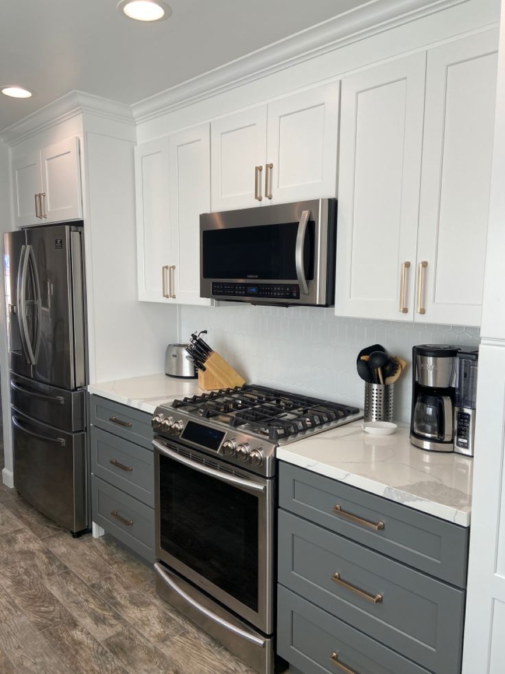 a kitchen with stainless steel appliances and white cabinets