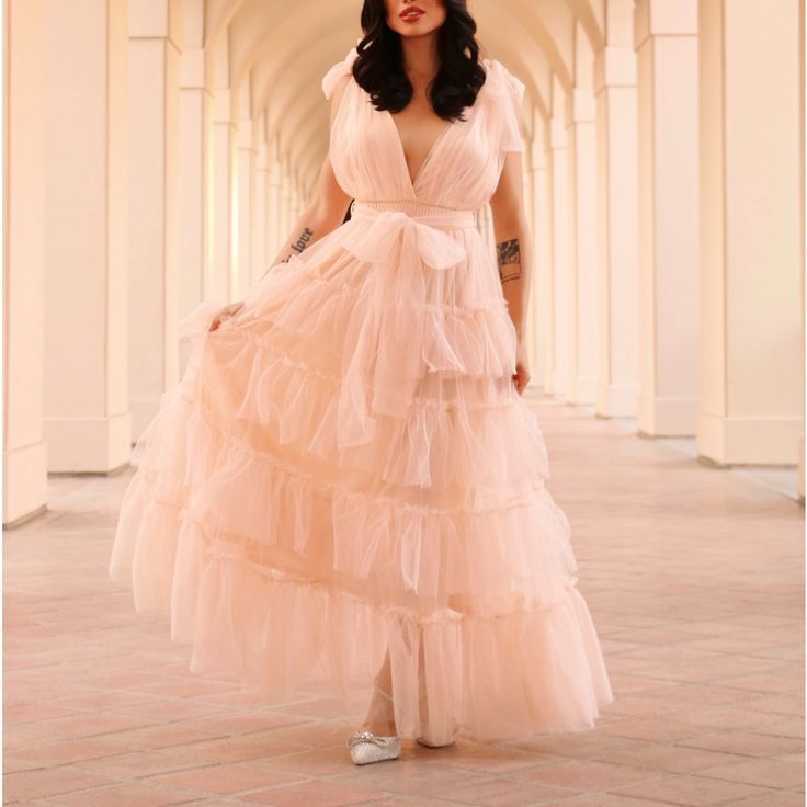 This Stunning Piece Features A Tulle Material, Adjustable Ties On The Straps And Waist, A Smocked And Stretchy Waist, A Petticoat, Lining And A Beautiful Tiered Yet Ruffled Skirt. It Is Nwt And In Perfect Condition. My Model Is Wearing A Size Small. She Is 5’4” With A 32c Bust And 25” Waist. Spring Tulle Maxi Dress In Ball Gown Shape, Spring Tulle Ball Gown Maxi Dress, Spring Tulle Maxi Ball Gown, Fitted Tulle Maxi Dress In Feminine Style, Feminine Fitted Tulle Maxi Dress, Fitted Feminine Tulle Maxi Dress, Pink Maxi Tulle Skirt Dress, Spring Floor-length Tulle Evening Dress, Summer Prom Ball Gown Maxi Dress