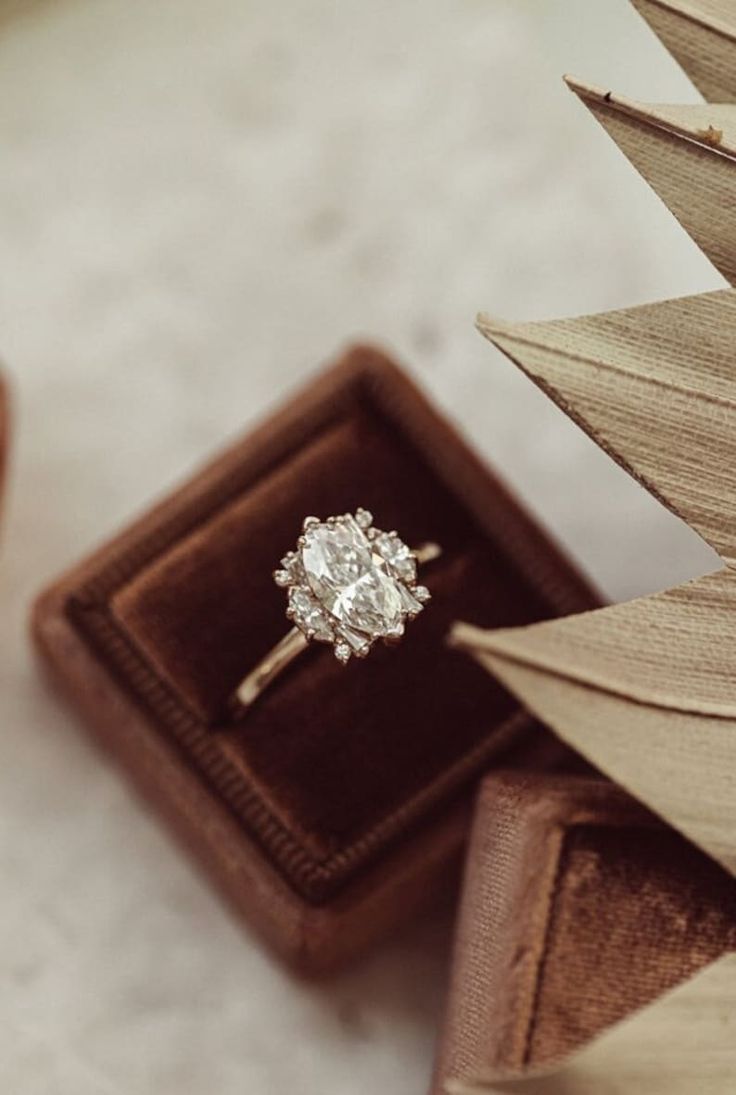 an engagement ring sitting in a box on top of a table