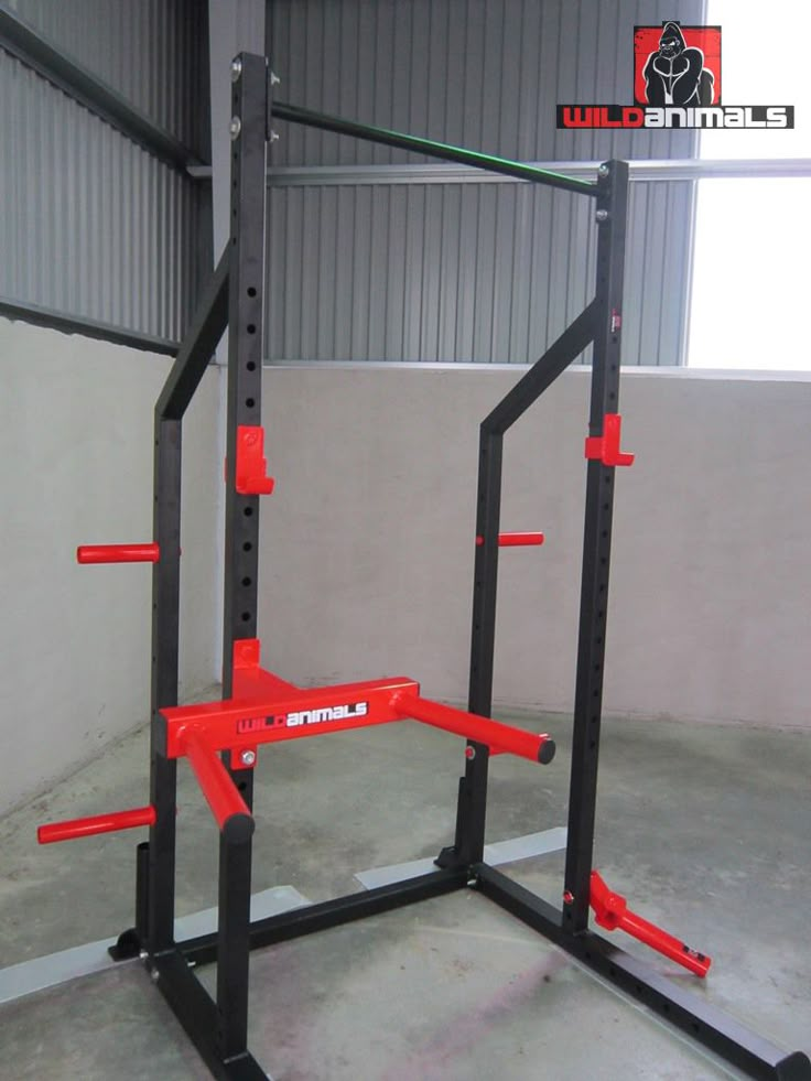 a red and black squat station in a garage with the door open to show it's weight capacity