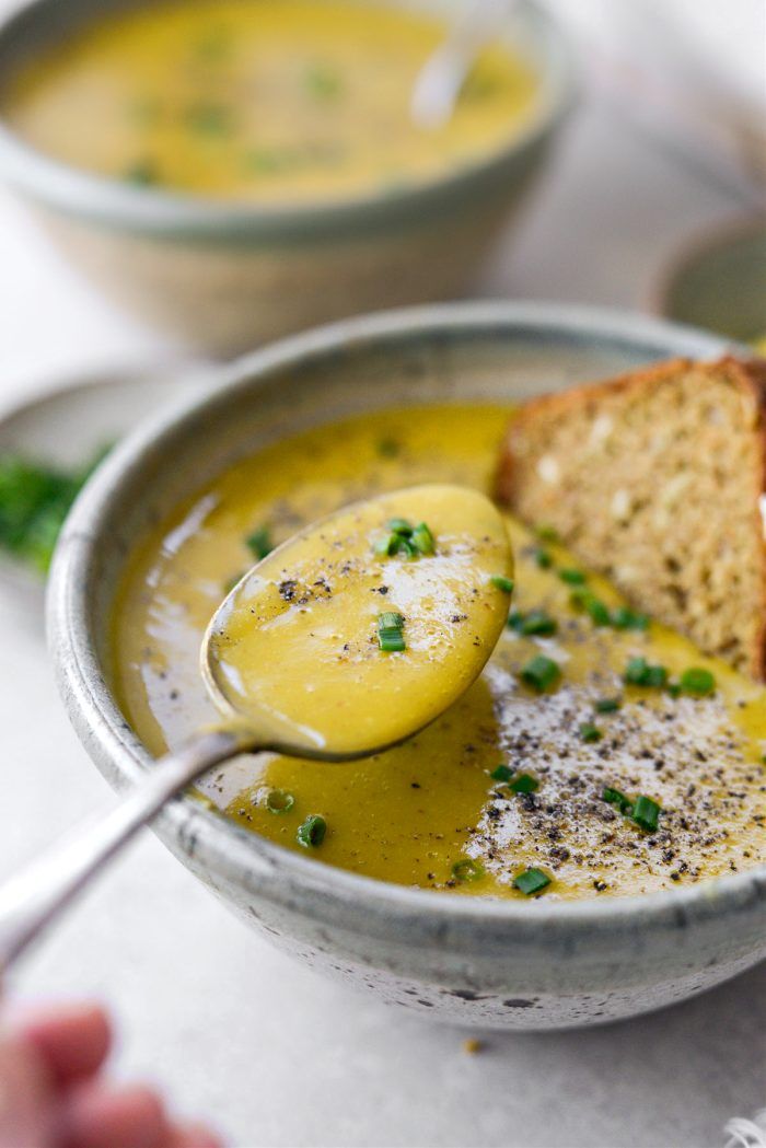 a bowl filled with soup and bread on top of a table